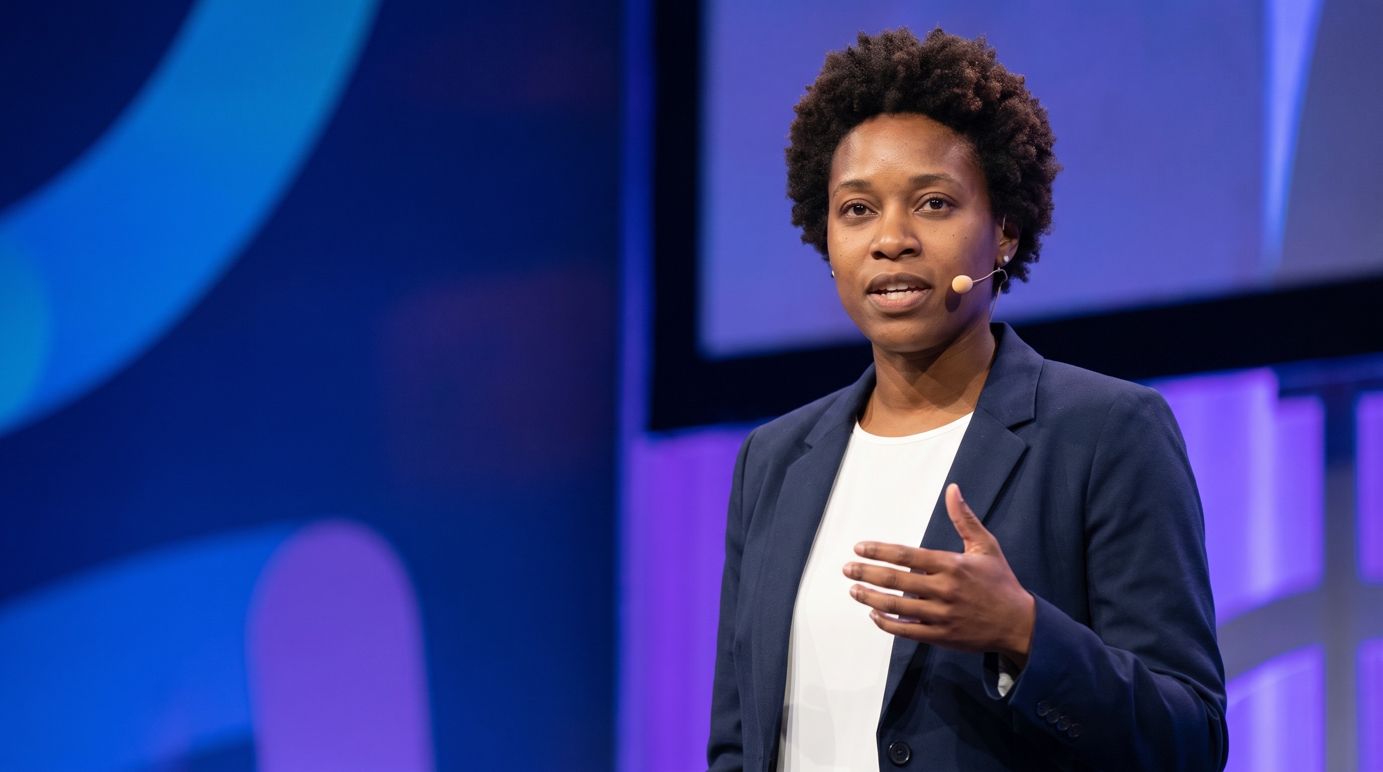 AI public speaker headshot on a keynote stage with a headset