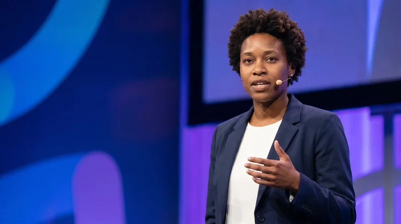 AI public speaker headshot on a keynote stage with a headset