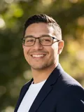 AI-generated professional headshot by still., made from the selfie beside it