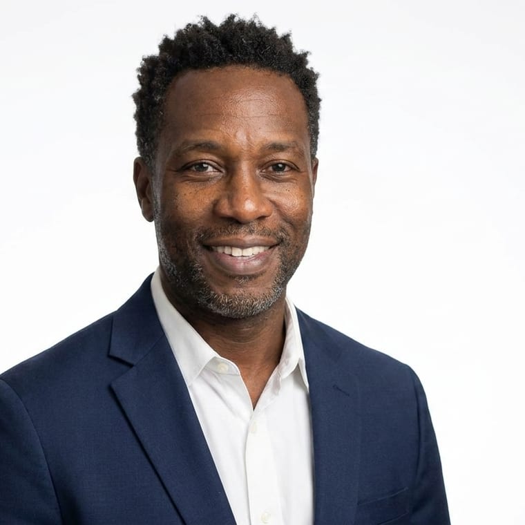 An agent in a navy blazer, on a clean white backdrop, softly lit, facing the camera square on.