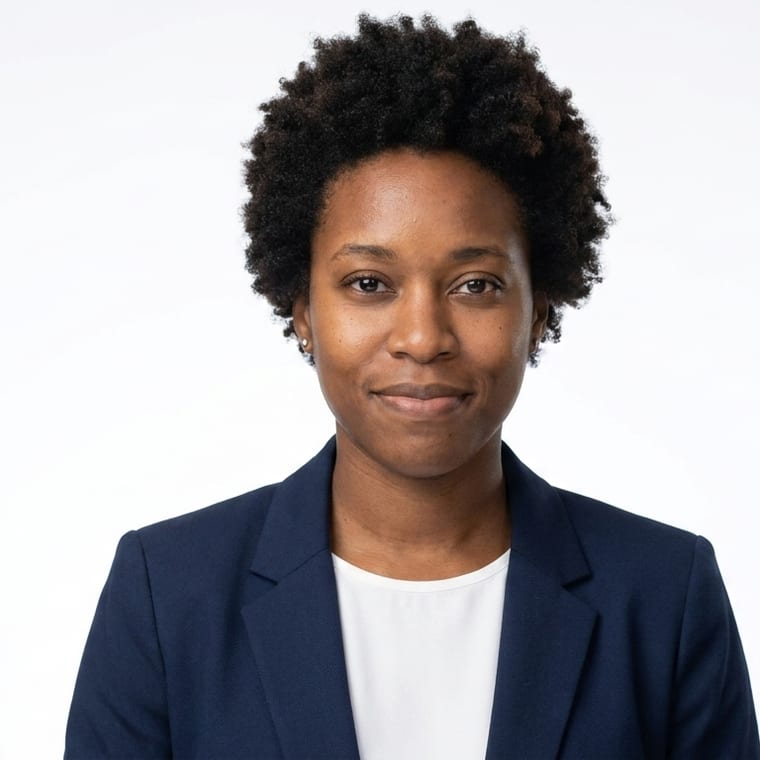 The same person on a plain white backdrop, lit with soft clamshell lighting, facing the camera square on.
