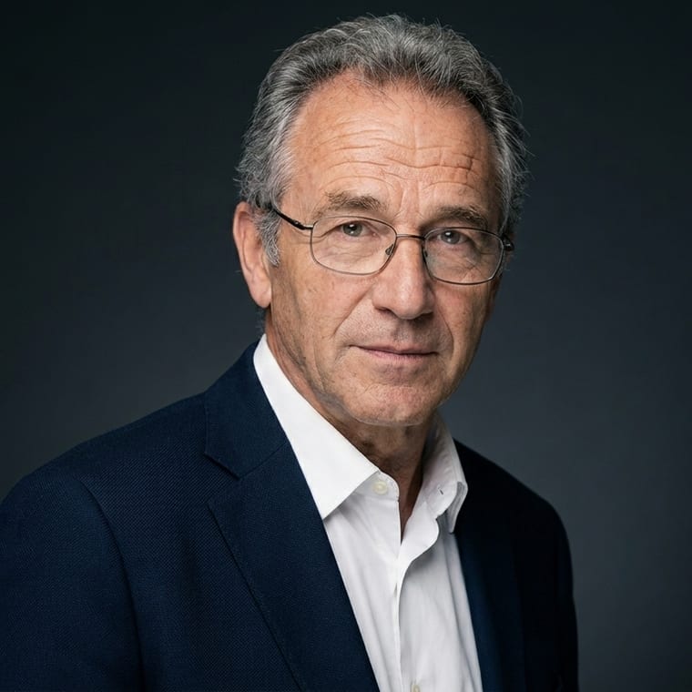 The same man on a dark studio background, lit with a Rembrandt key light, body turned three-quarters to the camera.
