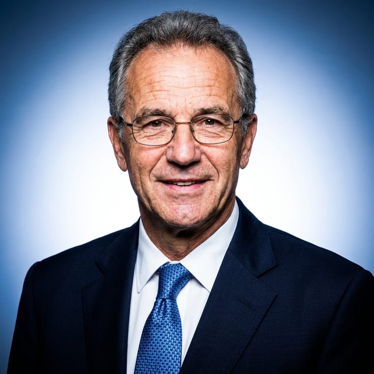 A studio headshot lit with a hard flash, on a blue gradient backdrop, skin retouched smooth